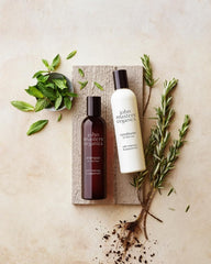 John Masters Organics volumizing conditioner label highlighting rosemary and peppermint benefits
