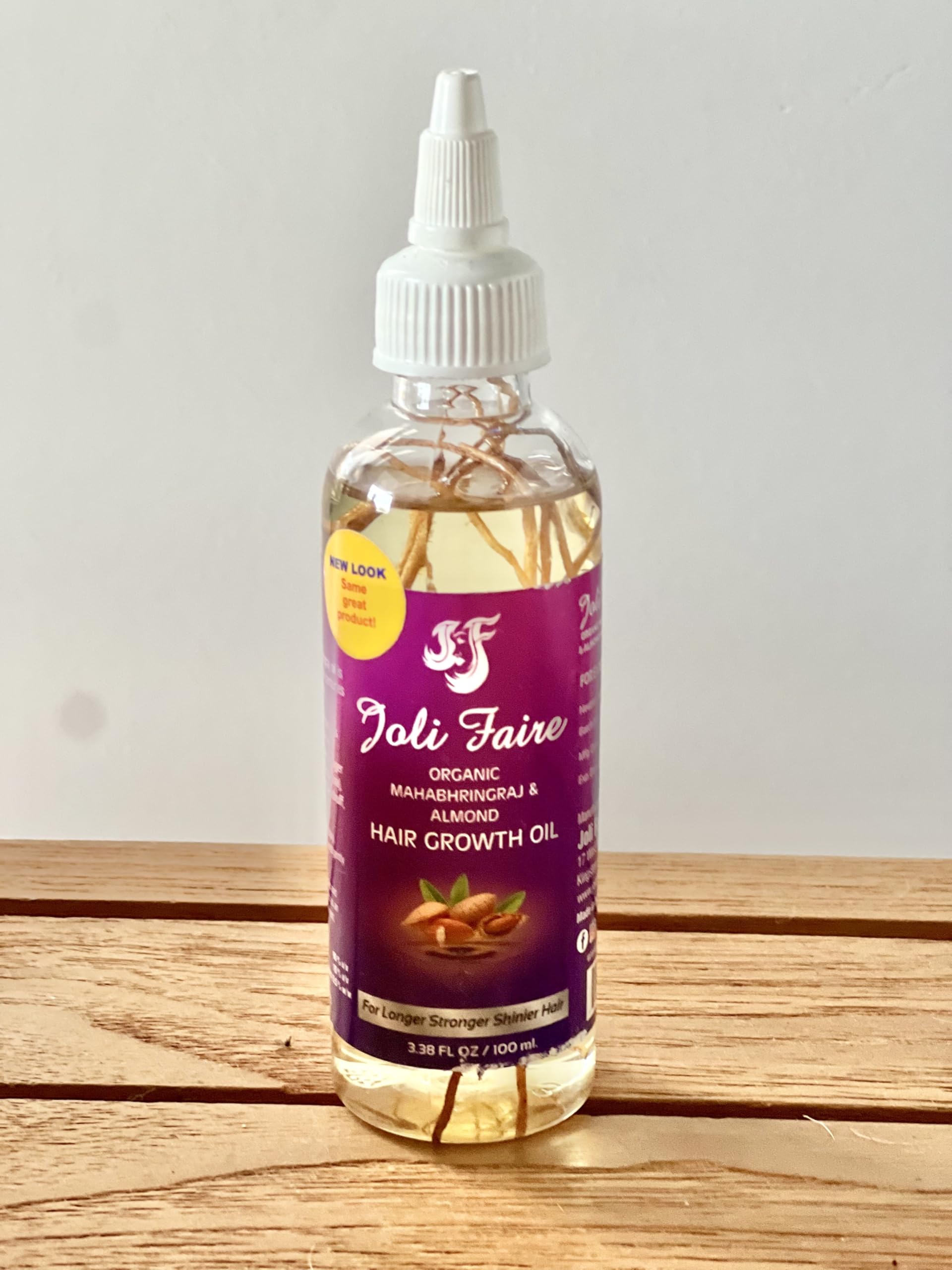 Joli Faire Hair Growth Oil applied to scalp to support thinning areas.