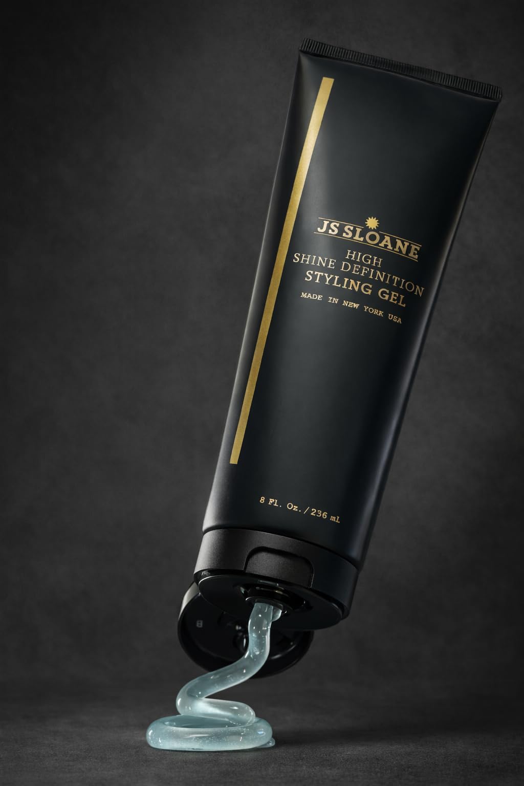 JS SLOANE styling gel bottle close-up dispensing for easy application.