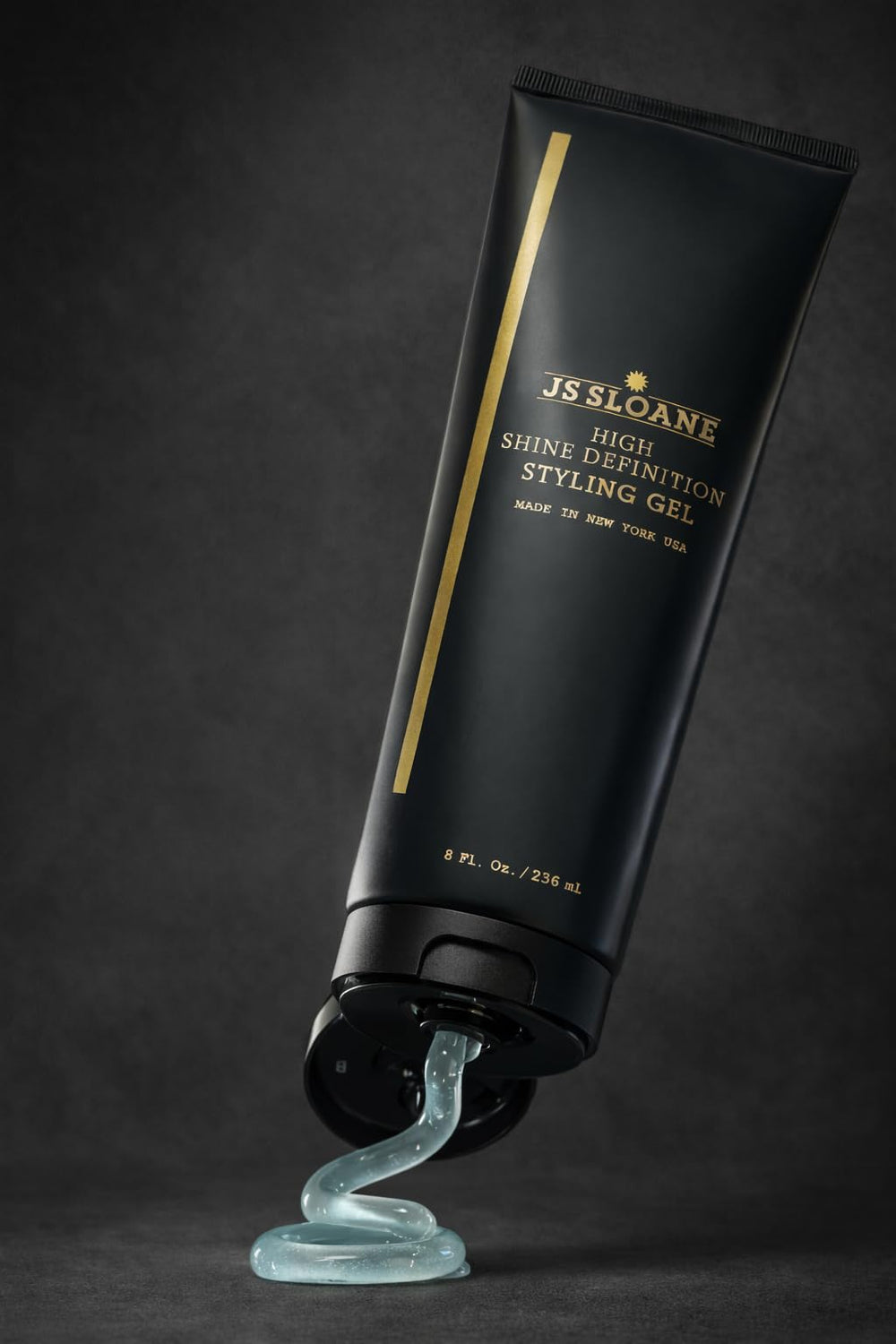 JS SLOANE styling gel bottle close-up dispensing for easy application.