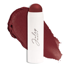 Julep Skip The Brush Passion Fruit blush stick applied on cheeks for a dewy glow.