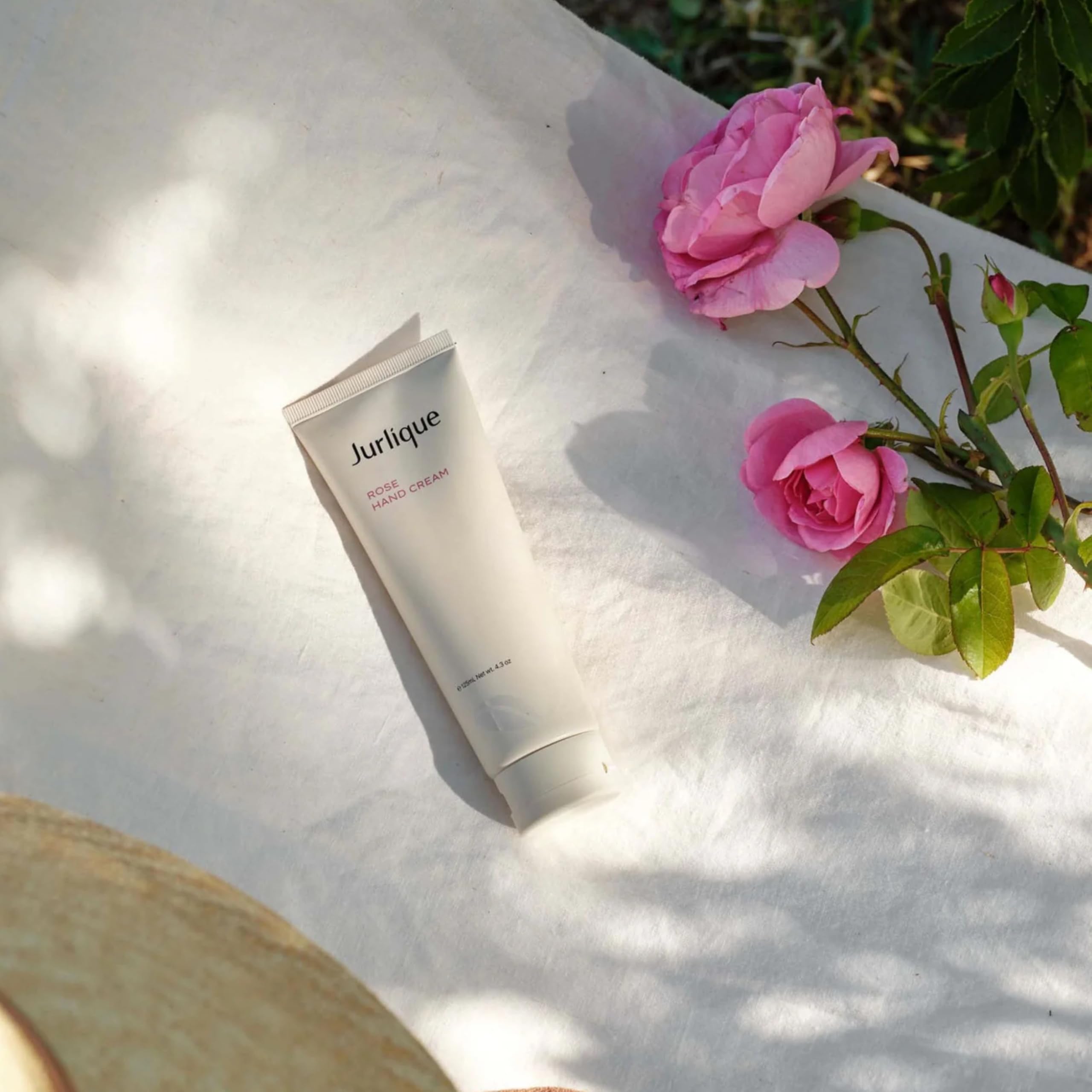 Hands applying Jurlique Rose Hand Cream for daily moisturizing.