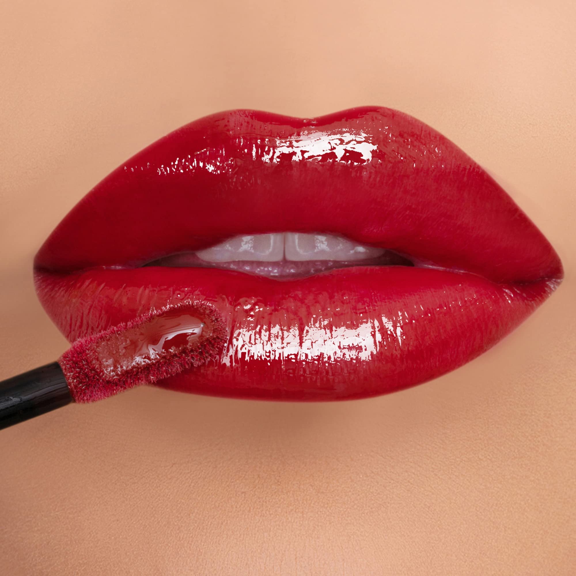 K7L Hustle red lip gloss tube close-up with rich color payoff.
