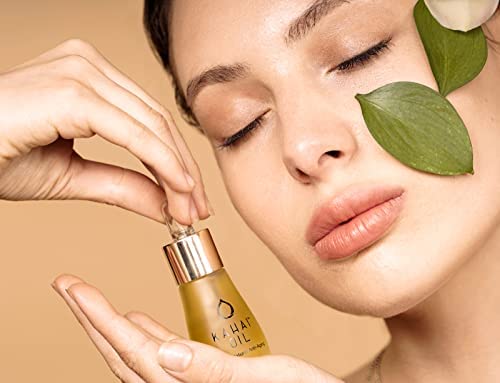 Applying Kahai Oil to the face for lasting hydration and glow.