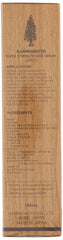 Close-up of Kaminomoto regrowth treatment gold label bottle designed for daily scalp nourishment.