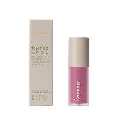 Karuna Tinted Lip Oil applied to lips reveals light color and hydrating shine.