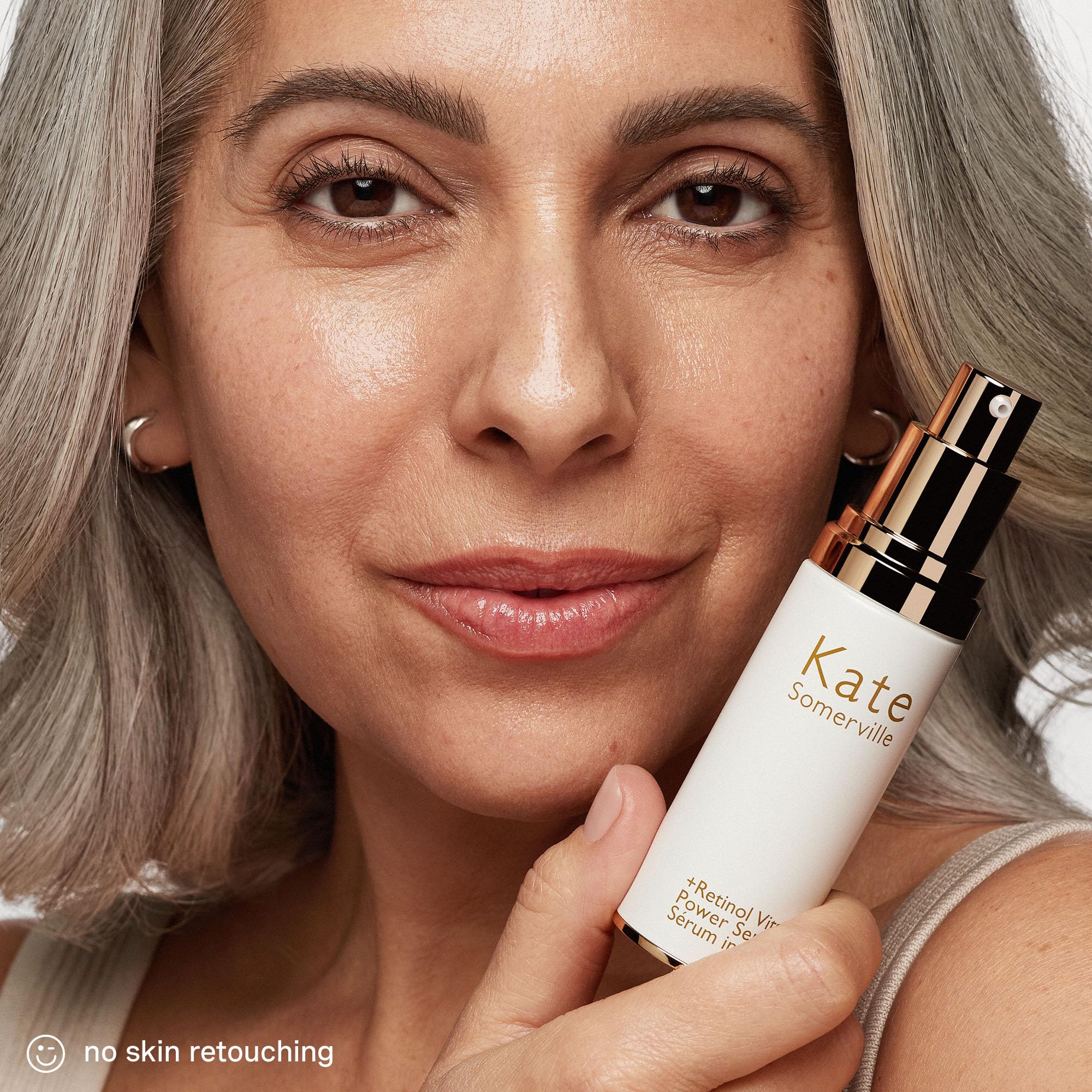 Glass bottle on a drawer featuring Kate Somerville Retinol Vita C Power Serum