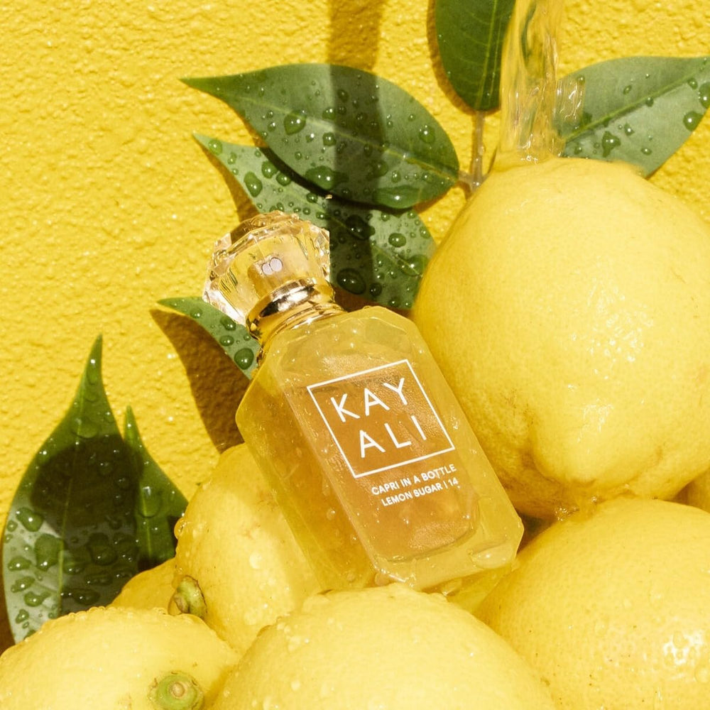 Kayali Capri Lemon Sugar spray action showing smooth pour for quick refreshing.