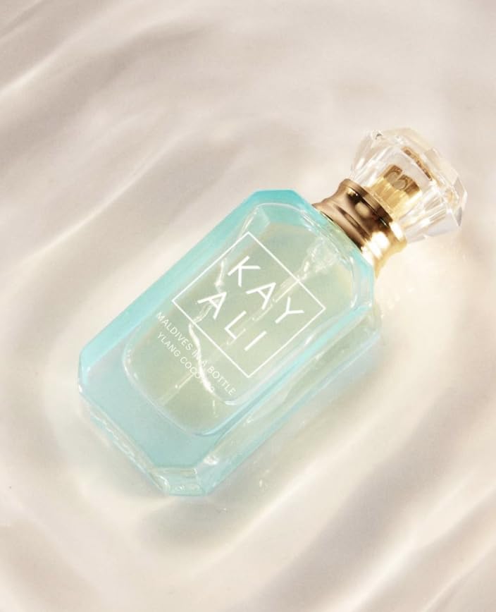 Beach scene with Kayali Maldives mini EDP, evoking tropical vibes for island-inspired moments.