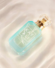 Beach scene with Kayali Maldives mini EDP, evoking tropical vibes for island-inspired moments.