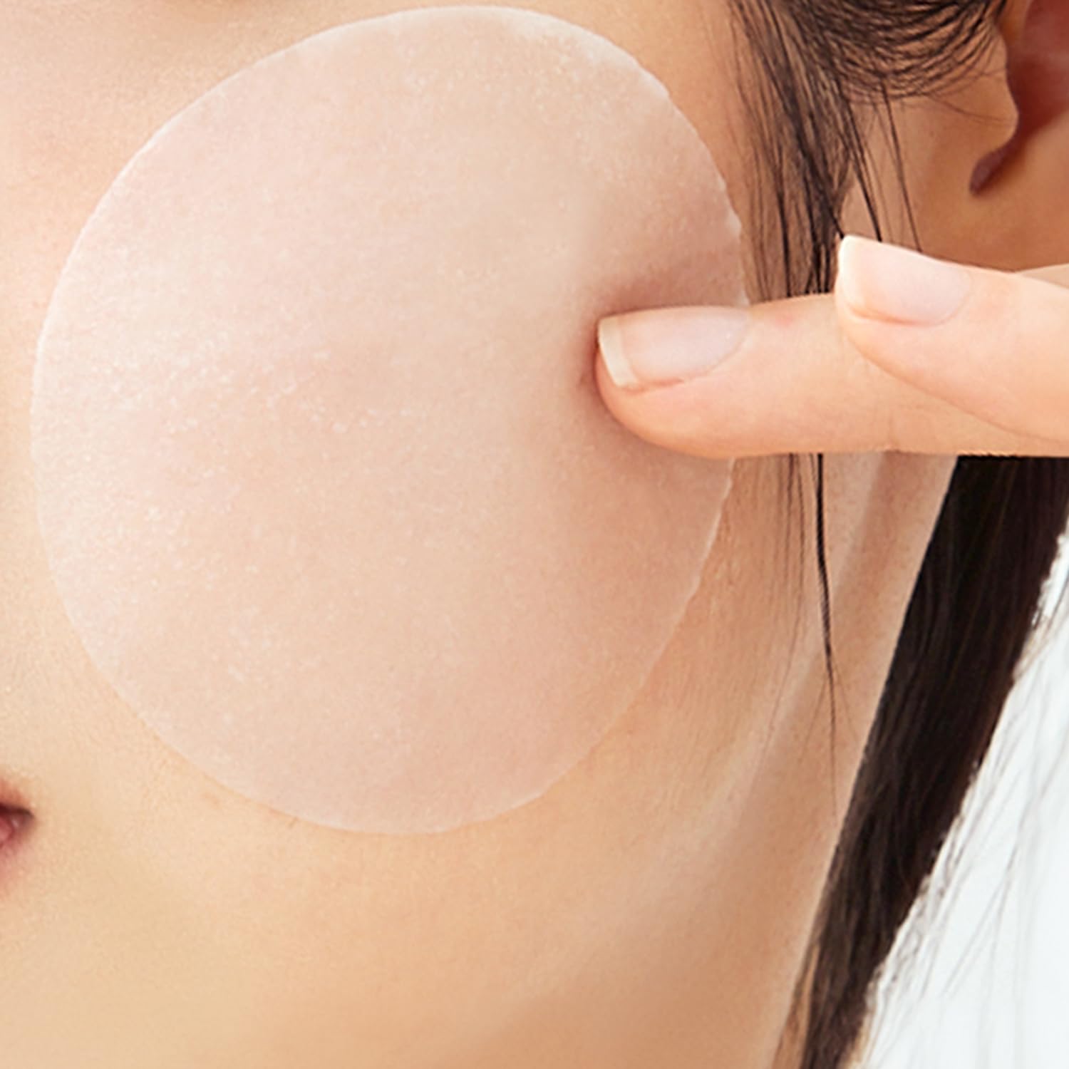 Applying Keenoniks toner pad to cheek demonstrates soothing daily routine