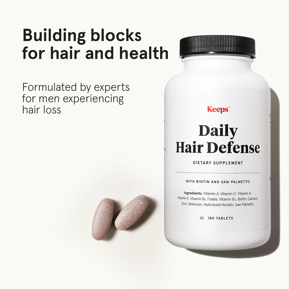 Close-up of Keeps hair growth tablets ready for a simple daily dose.