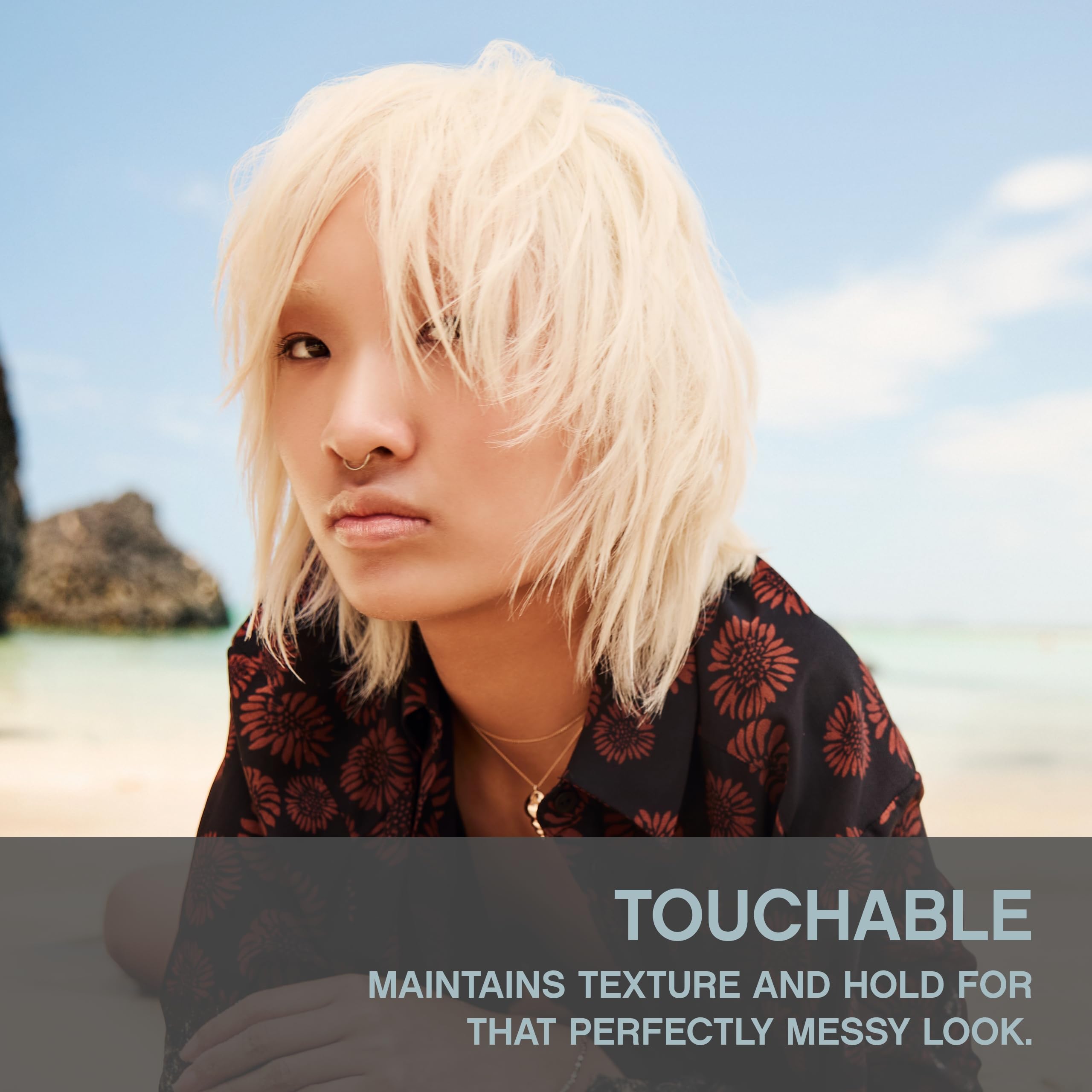 Close-up of KEVIN.MURPHY Touchable Spray Wax texture highlighting non-sticky feel.