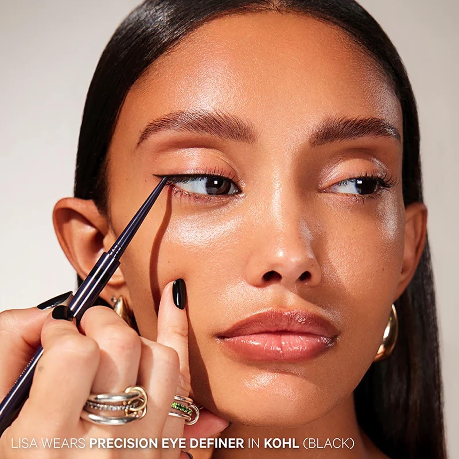 Applying Kevyn Aucoin Precision Eye Definer along the waterline for long-wear definition.