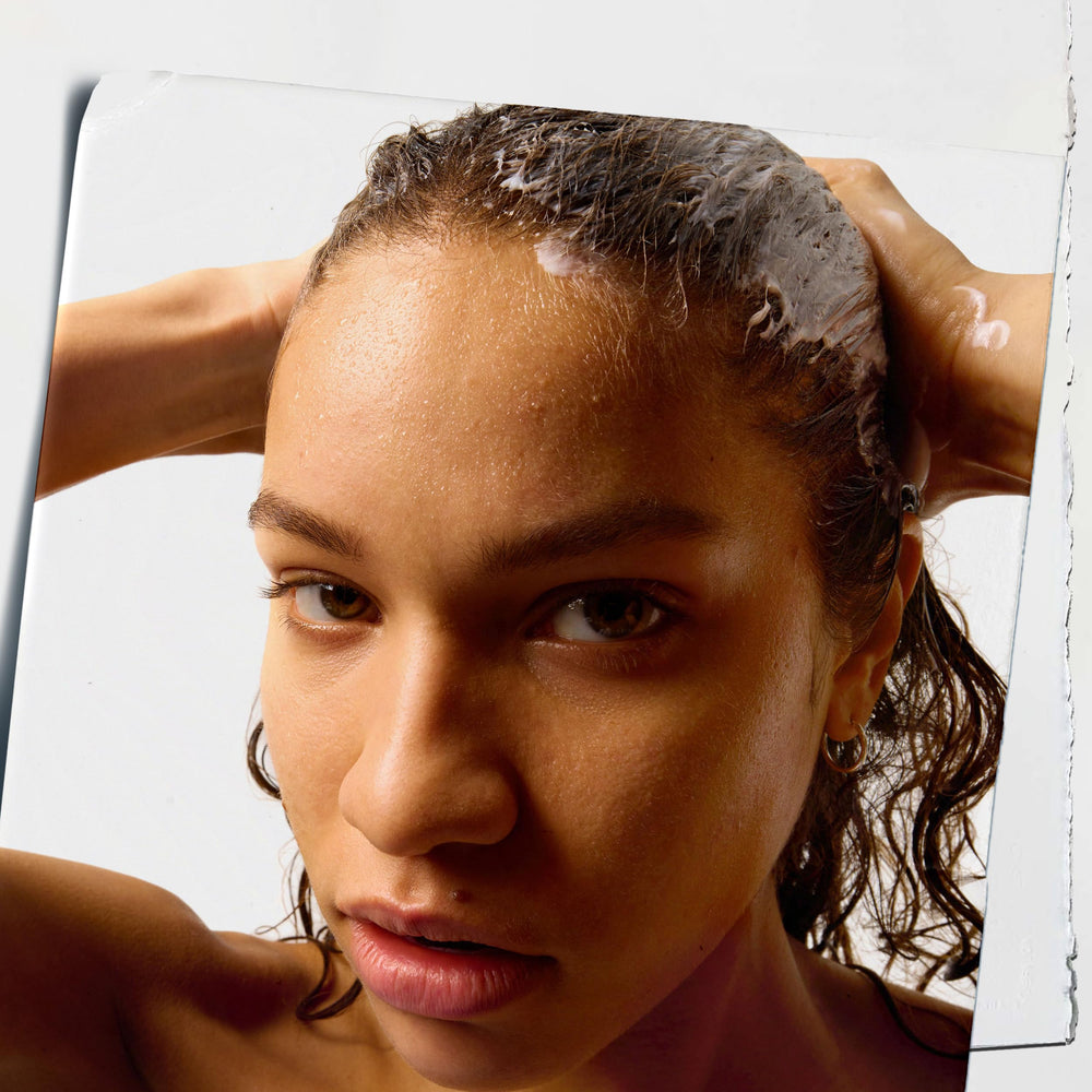 Kiehl's Amino Acid Conditioner applied to wet hair for detangling ease.