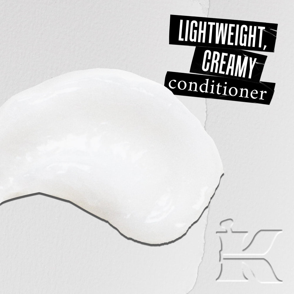 Kiehl's leave-in conditioner application on hands prepares hair for detangling.