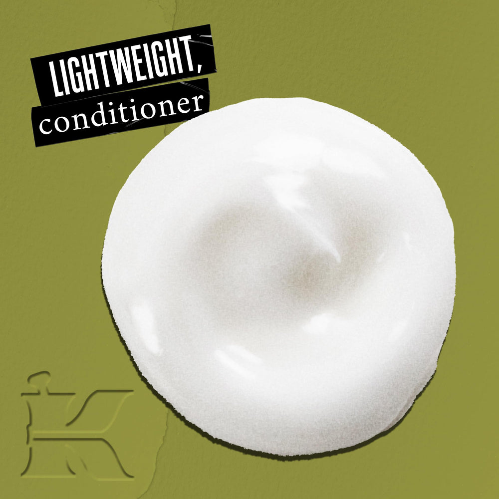 Close-up of olive fruit oil conditioner ingredients with olive, avocado, and lemon oils for moisture