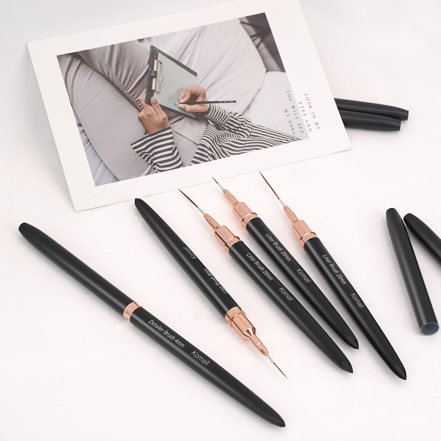 Komall metallic nail art brush handle detail shows ergonomic grip and premium quality.