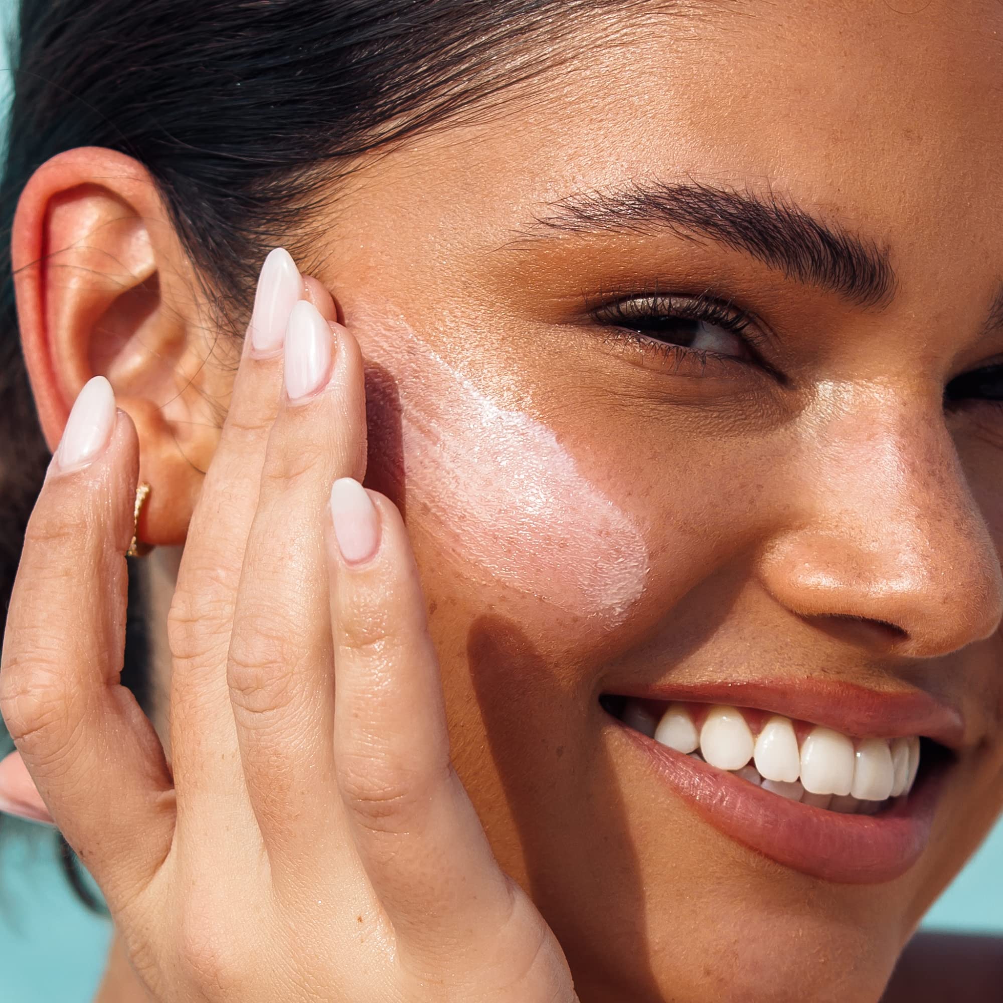 Kopari Antioxidant Face Shield being applied to face and neck for daily protection.