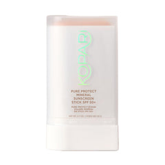 Kopari Pure Protect SPF 50+ stick applying clear sunscreen on face and body for easy protection.