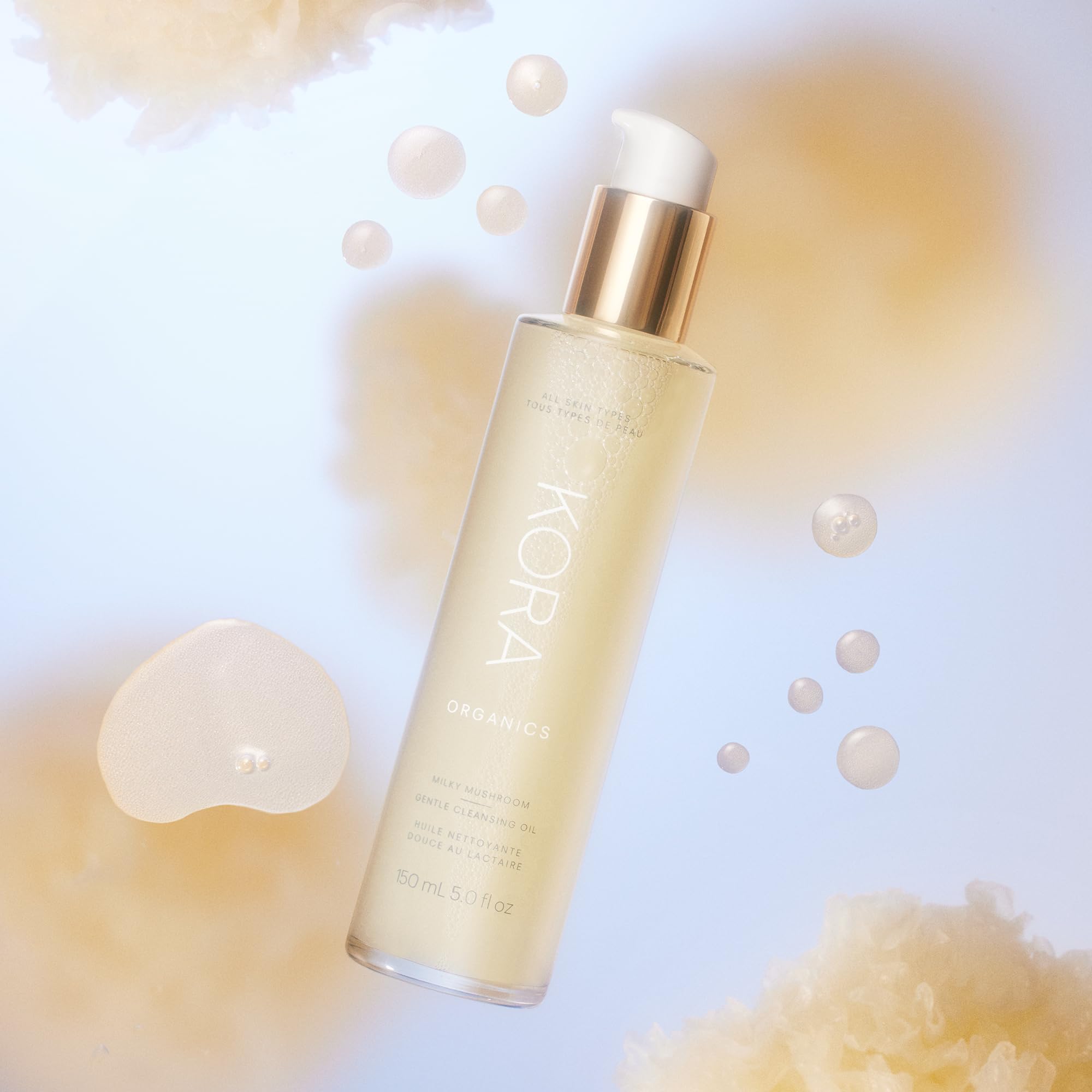KORA Organics Milky Mushroom Oil Cleanser applying to damp skin for a supple feel.