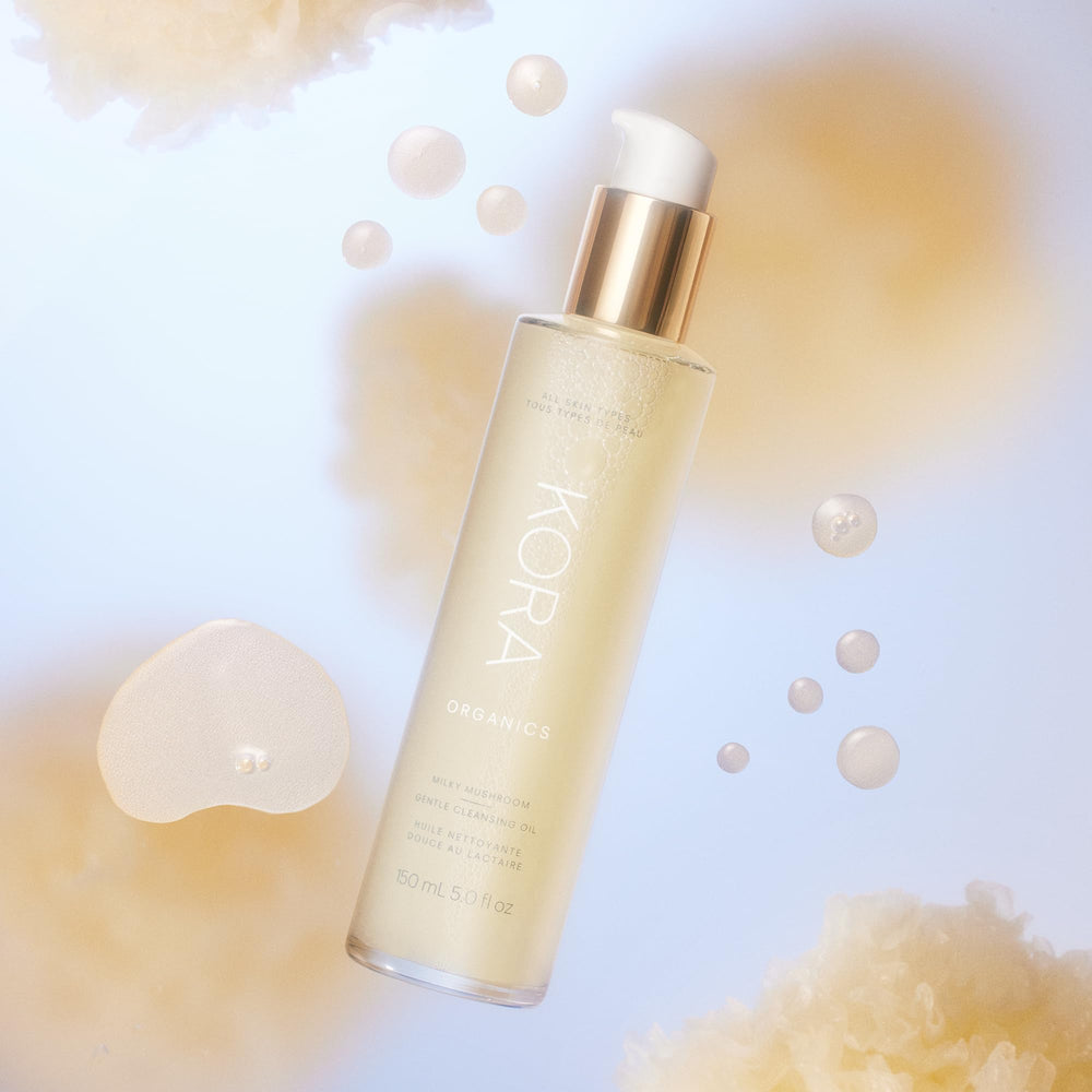 KORA Organics Milky Mushroom Oil Cleanser applying to damp skin for a supple feel.