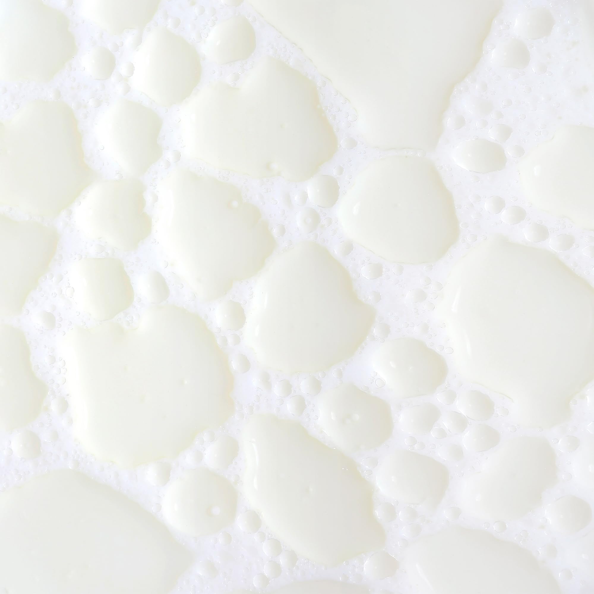 KORA Organics Milky Mushroom Oil Cleanser being shaken to activate creamy milk texture.