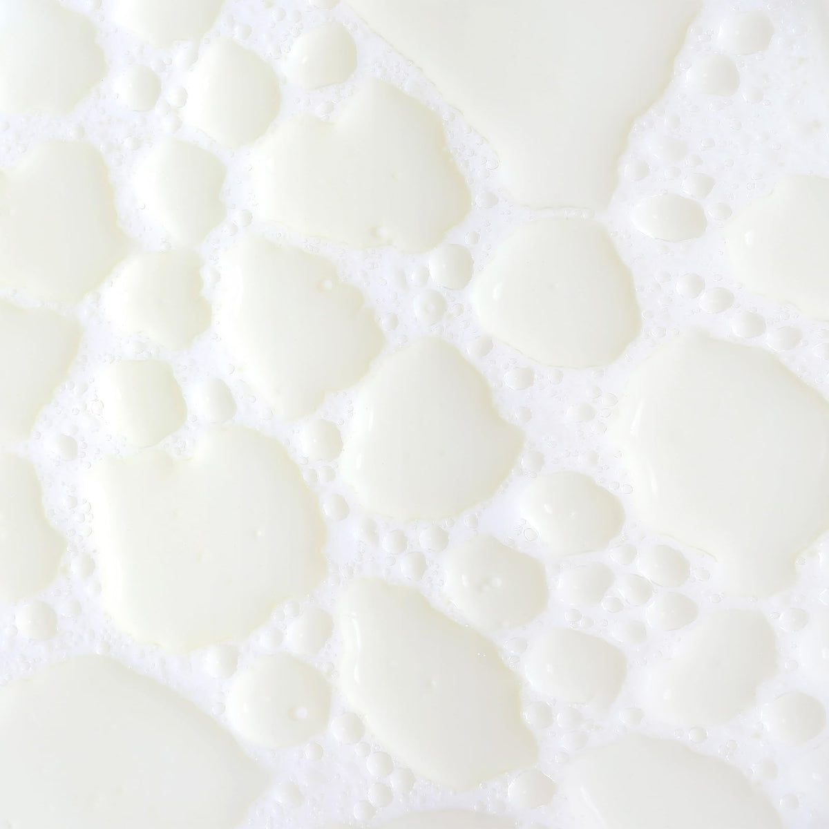 KORA Organics Milky Mushroom Oil Cleanser being shaken to activate creamy milk texture.