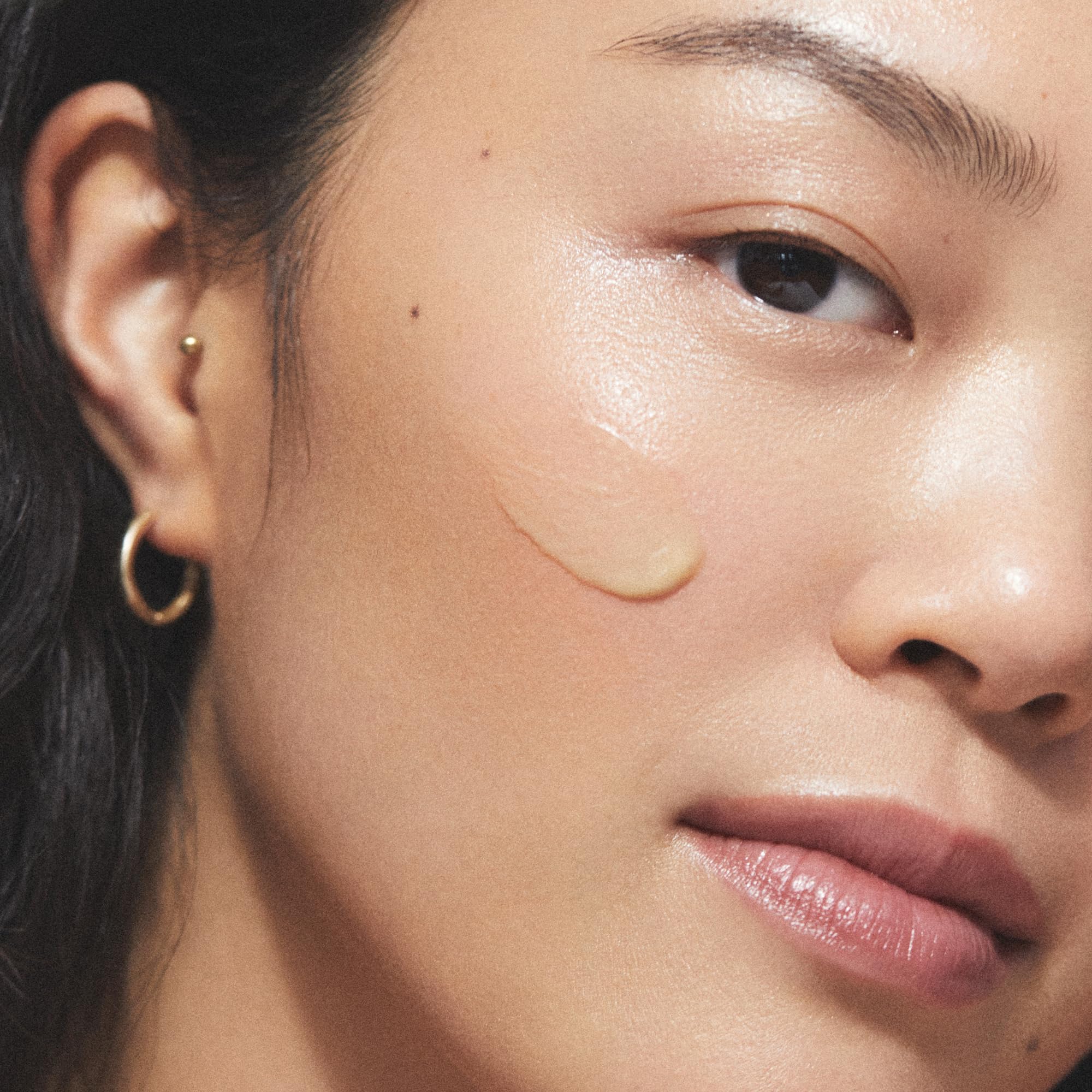 KORA Organics Noni Night AHA Serum on clean skin during night routine