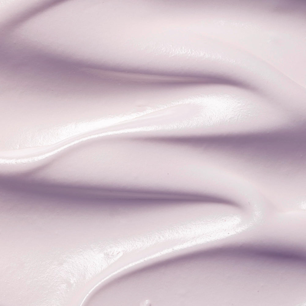 KORA Organics moisturizer jar closeup showing creamy texture.