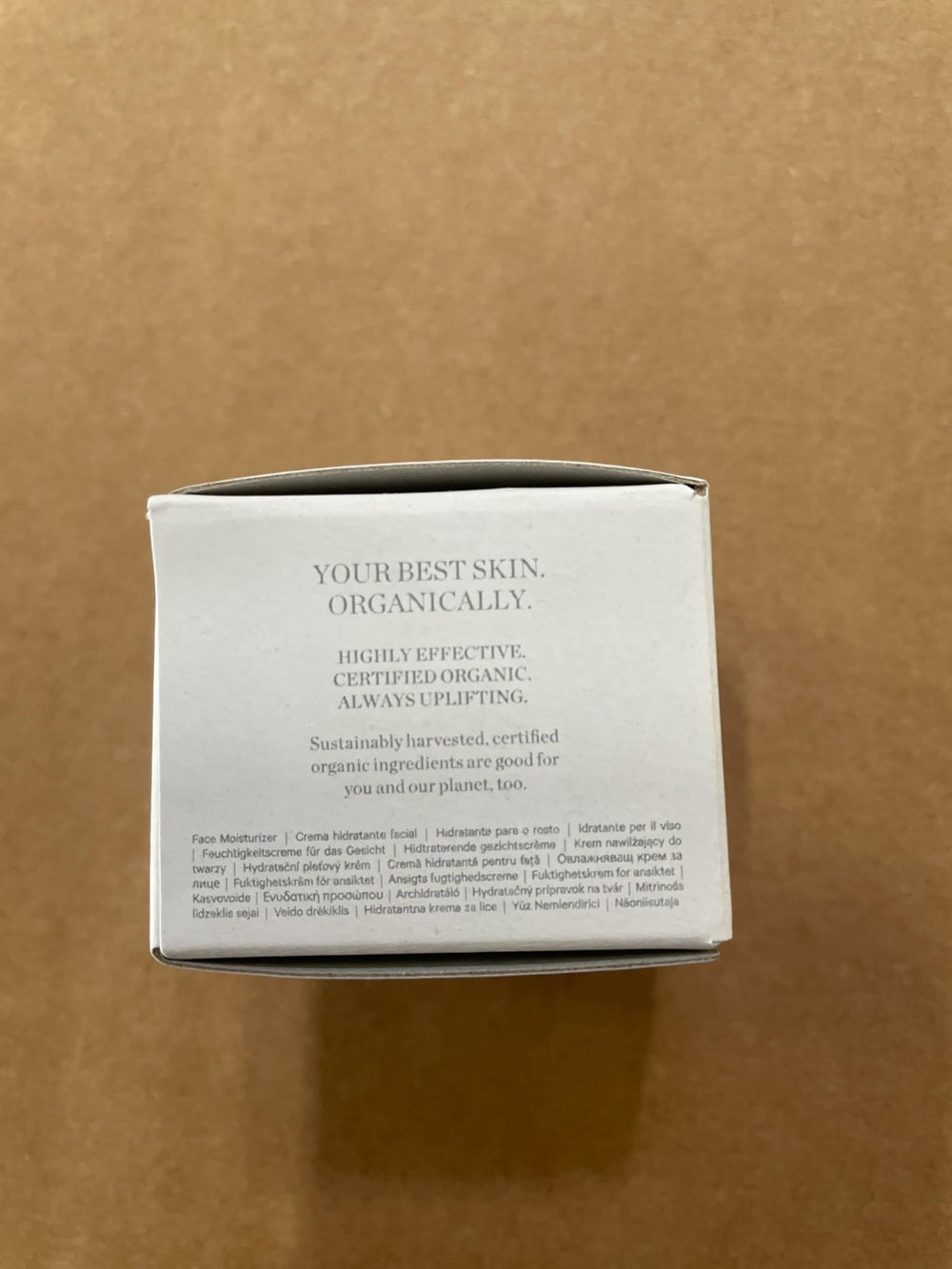 KORA Organics moisturizer on dresser with natural lighting.