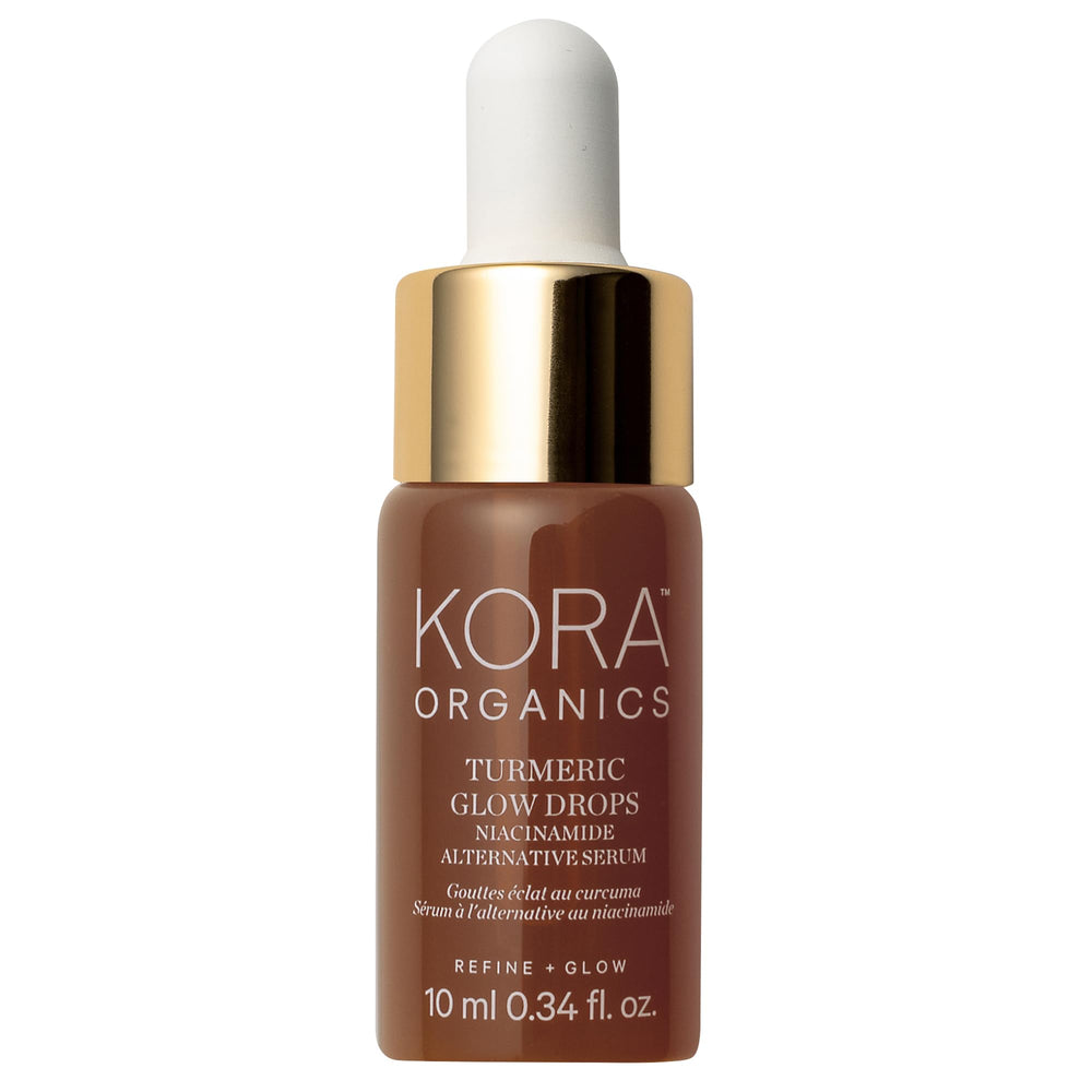 KORA Organics Turmeric Glow Drops bottle promotes a radiant complexion on a clean surface.