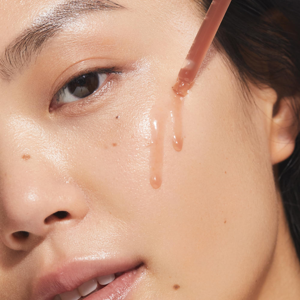 KORA Organics Turmeric Glow Drops ingredients close-up highlights turmeric and crowberry for balanced tone.