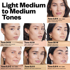 Under-eye area applying Revealer Concealer for a brightened, refreshed look.