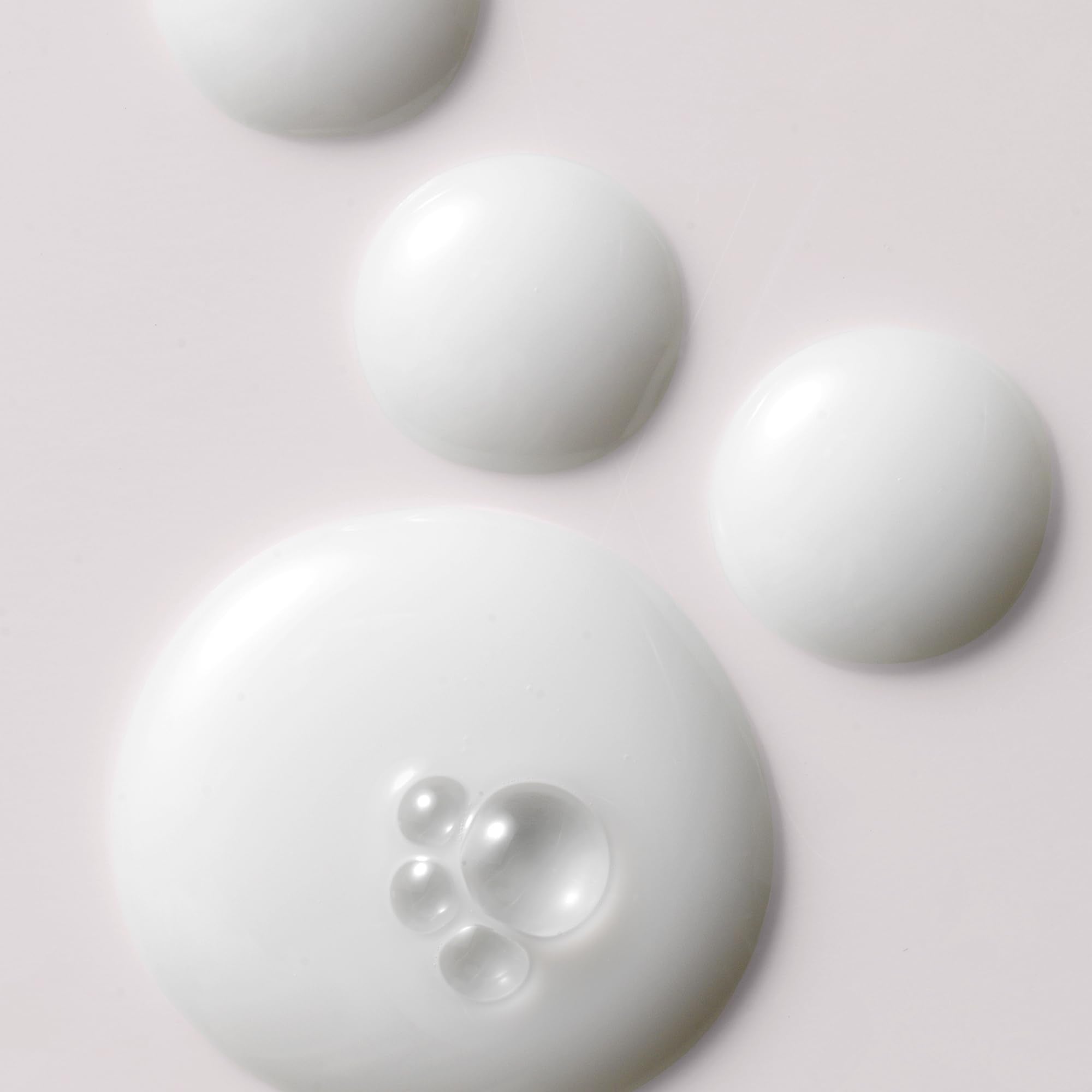 Kristin Ess Anytime Anywhere Scalp Oil application on scalp demonstrating soothing, hydrating action.