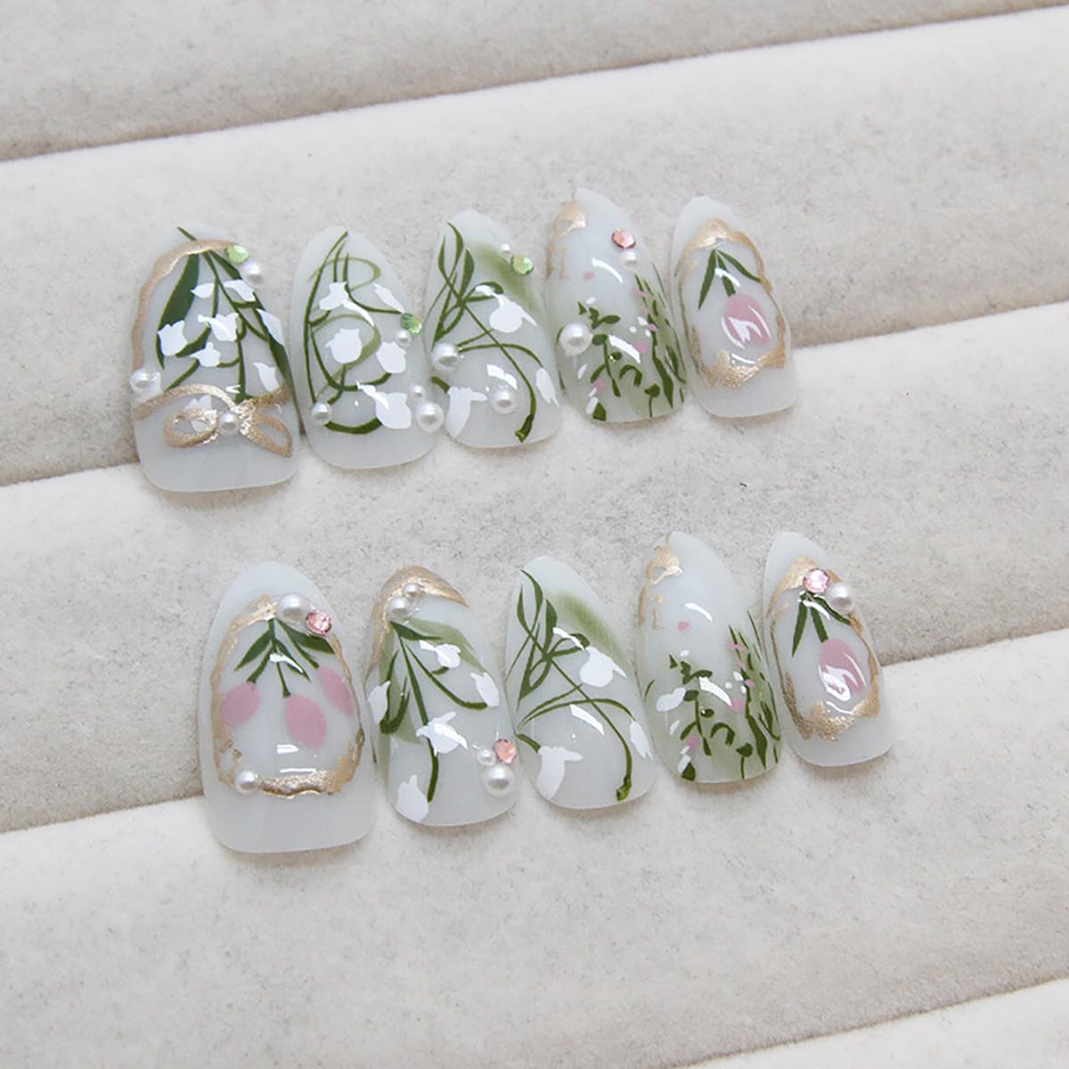 KRTBKR Gold French tips accent nails for a chic, versatile finish.