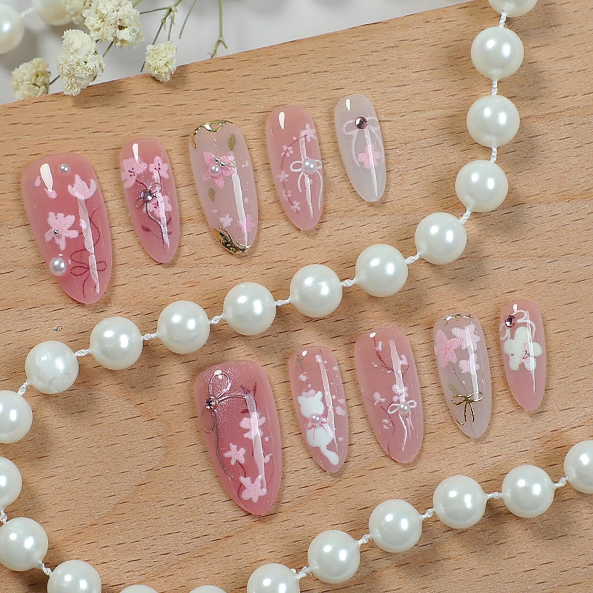 KRTBKR peach blossom nails with 3D rhinestones add festive sparkle