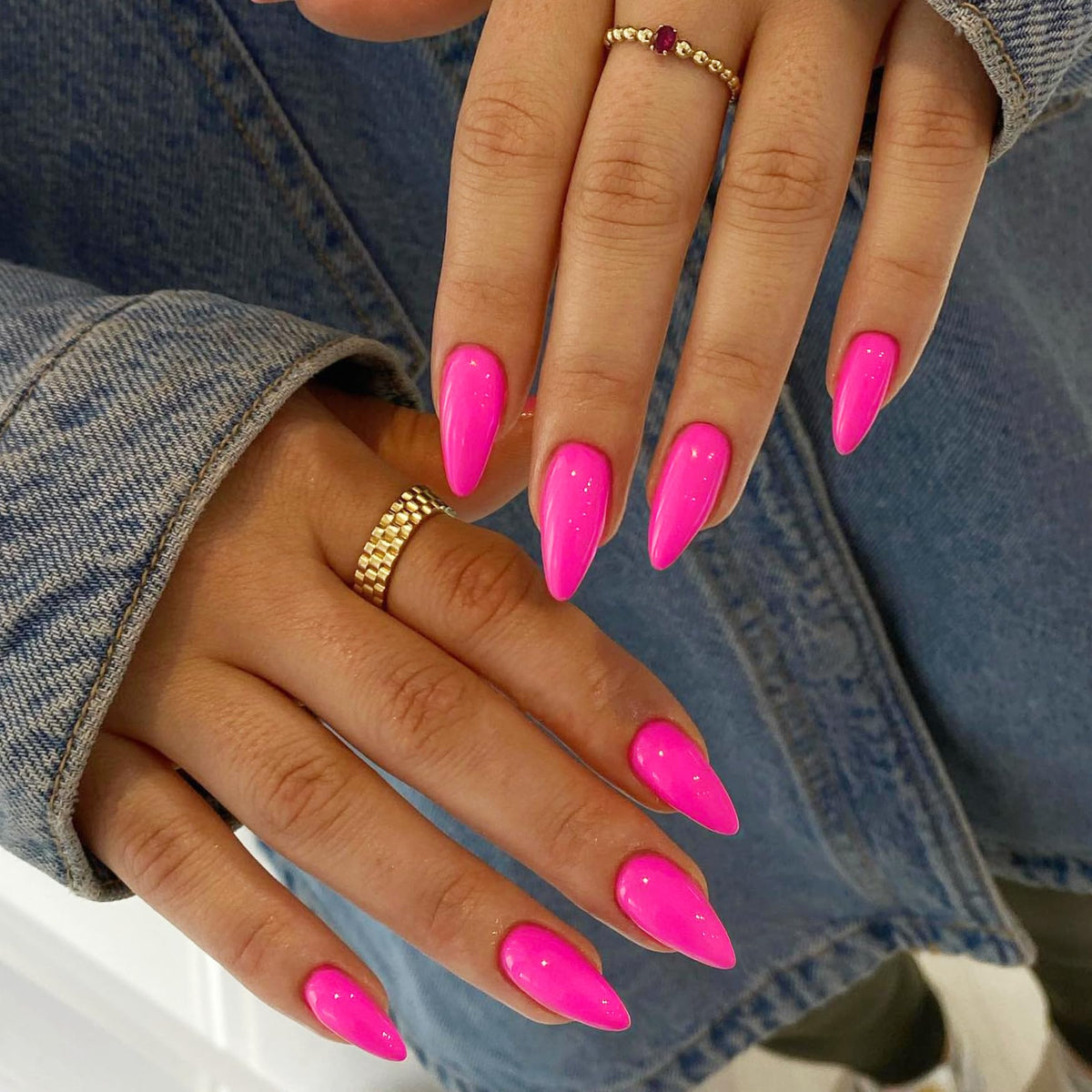 KXAMELIE hot pink press-on almond nails close-up with smooth gel finish for a salon-like look