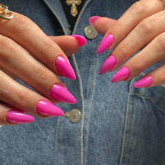 KXAMELIE hot pink press-on almond nails on hand showing natural fit