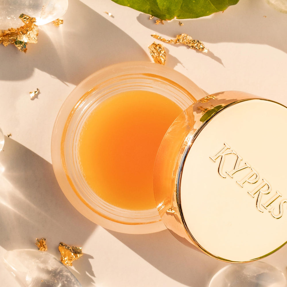 KYPRIS Lip Elixir Balm travel-size compact on a neutral background.