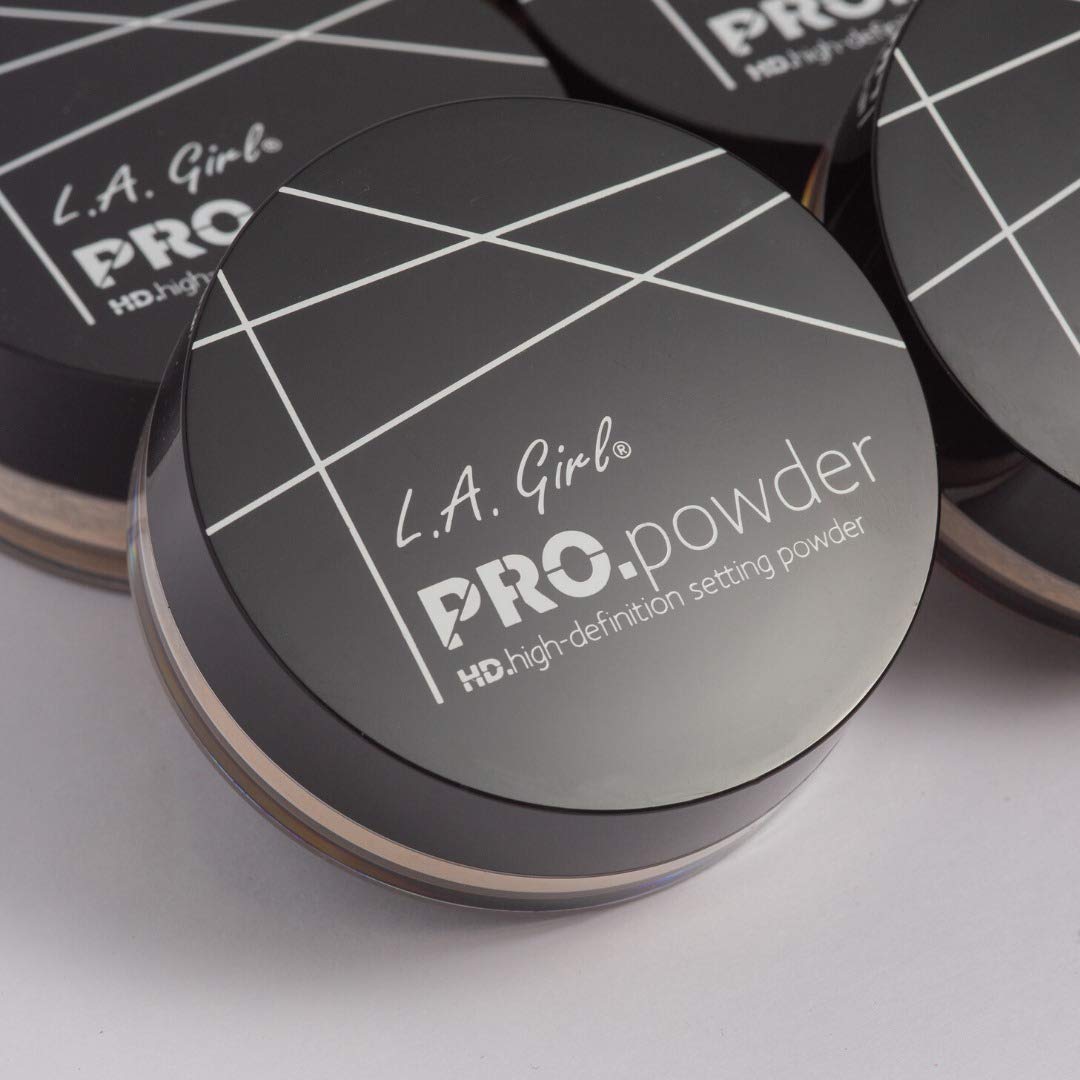 Hands applying L.A. Girl BB Pro Powder translucent with brush