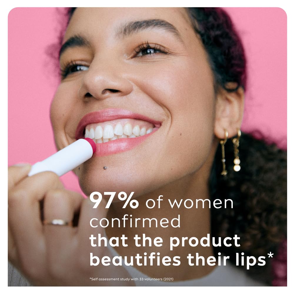 Labello Cherry lip balm on fingertip creates subtle lip shine.