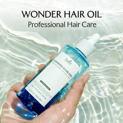 Applying LA'DOR Wonder Hair Oil for smooth frizz-free hair