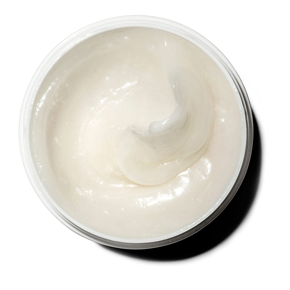 Jar being applied as creamy body moisturizer