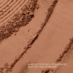 Lancôme Dual Finish swatch blending sheer-to-full coverage on skin tone