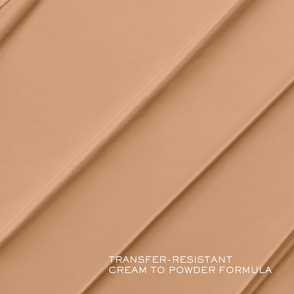 Lancôme Teint Idôle texture close-up shows creamy formula blending into skin.