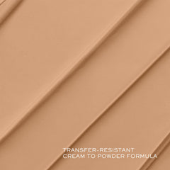 Lancôme Teint Idôle texture close-up shows creamy formula blending into skin.