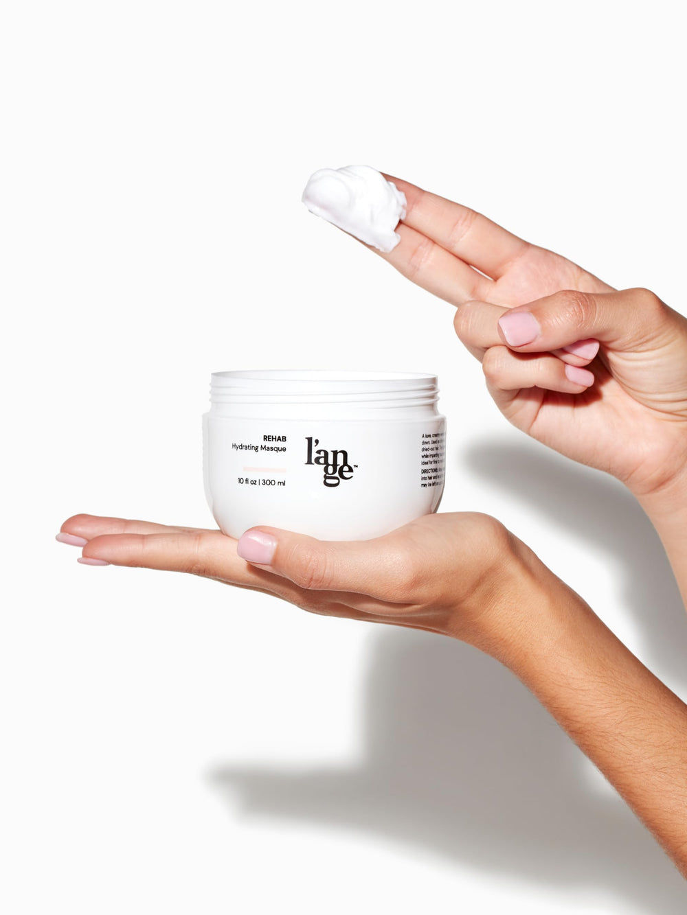 L'ANGE HAIR Rehab Hydrating Masque in-use shot showing smoother, frizz-free strands.