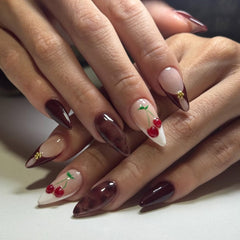 Lankensuixi long almond press-on nails in burgundy nude with gold studs for elegant evenings