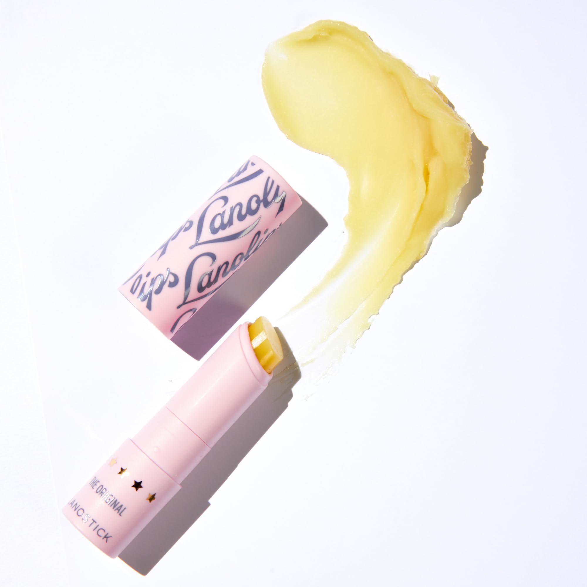 Lanolips Lanostick ingredients-castor-jojoba-lanolin close-up highlights natural oils nourishing lips.